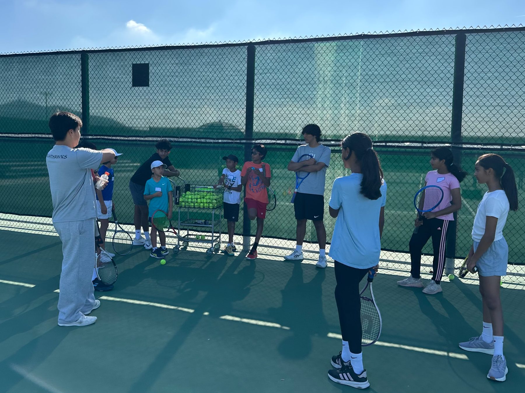 small group of 4 kids with one coach, focused drill