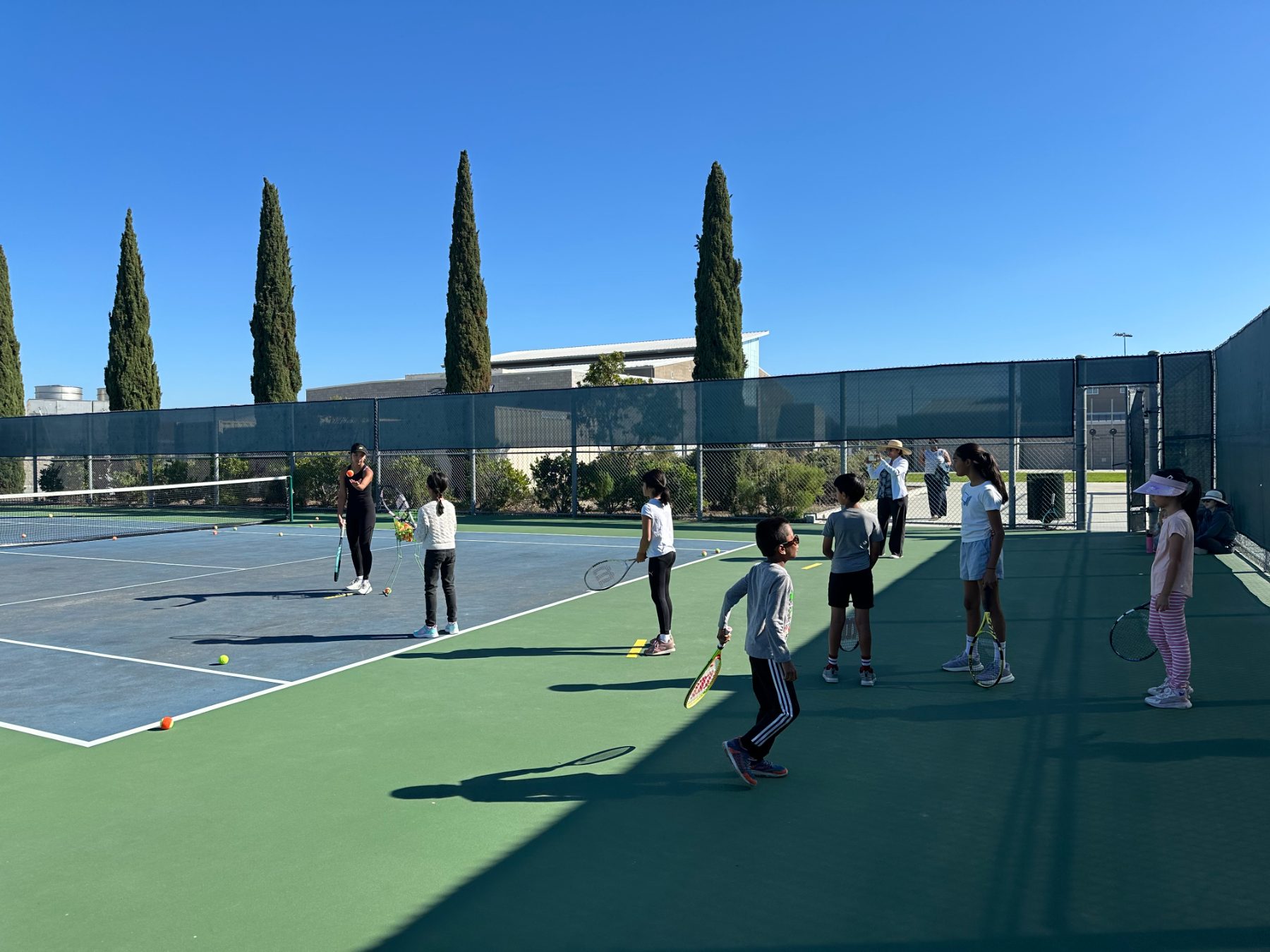 small group of 4 kids, 1 coach